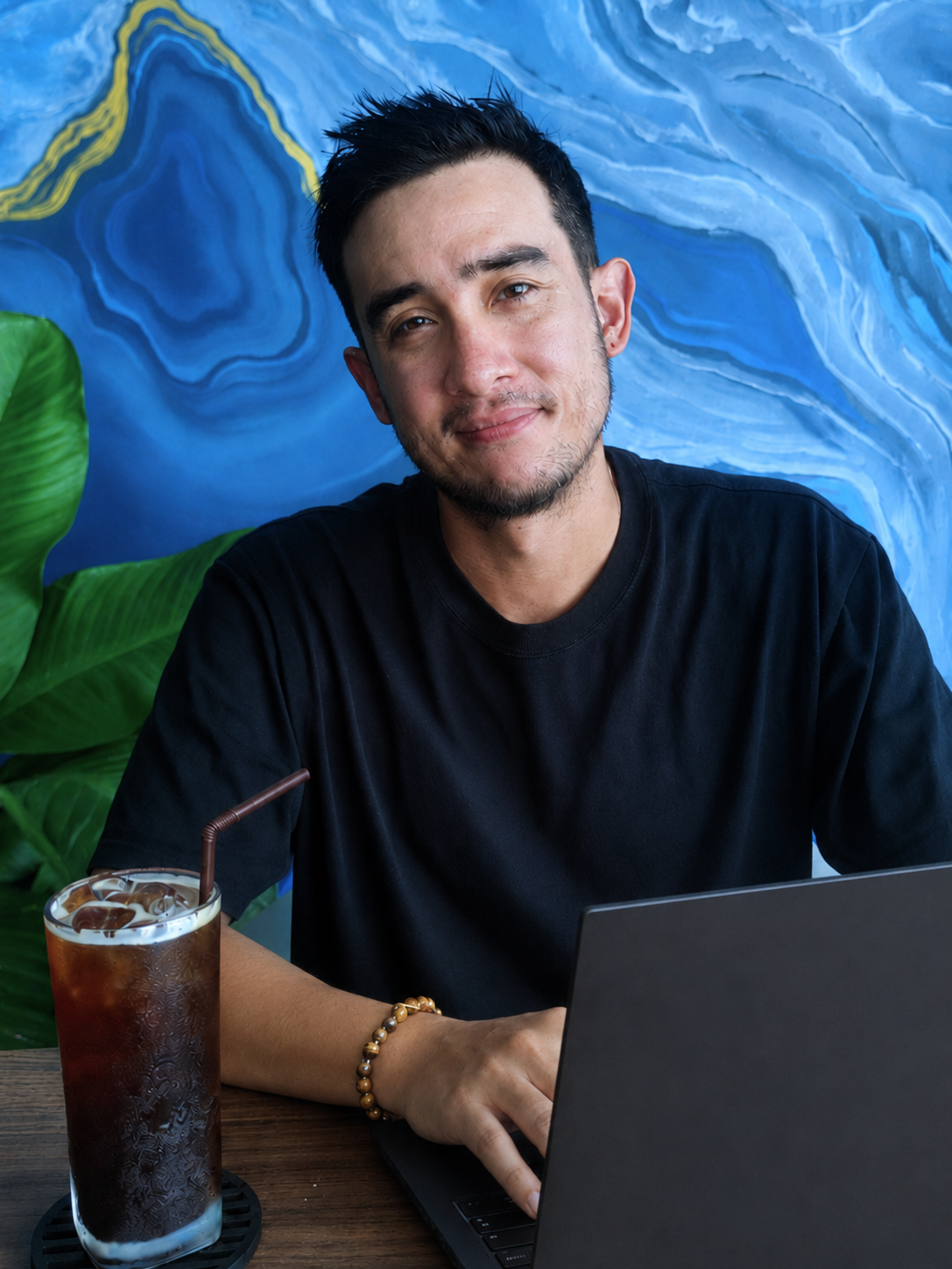 Image of Aaron at his desk in front of a laptop